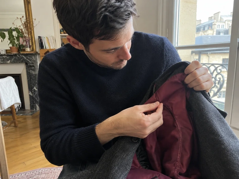 Une doublure de manteau est vérifiée près d’une fenêtre