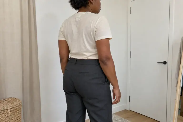 Une femme vérifie la taille d’un pantalon gris